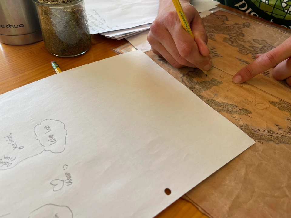 The heroes updating their map with Skydancer&rsquo;s pointers.