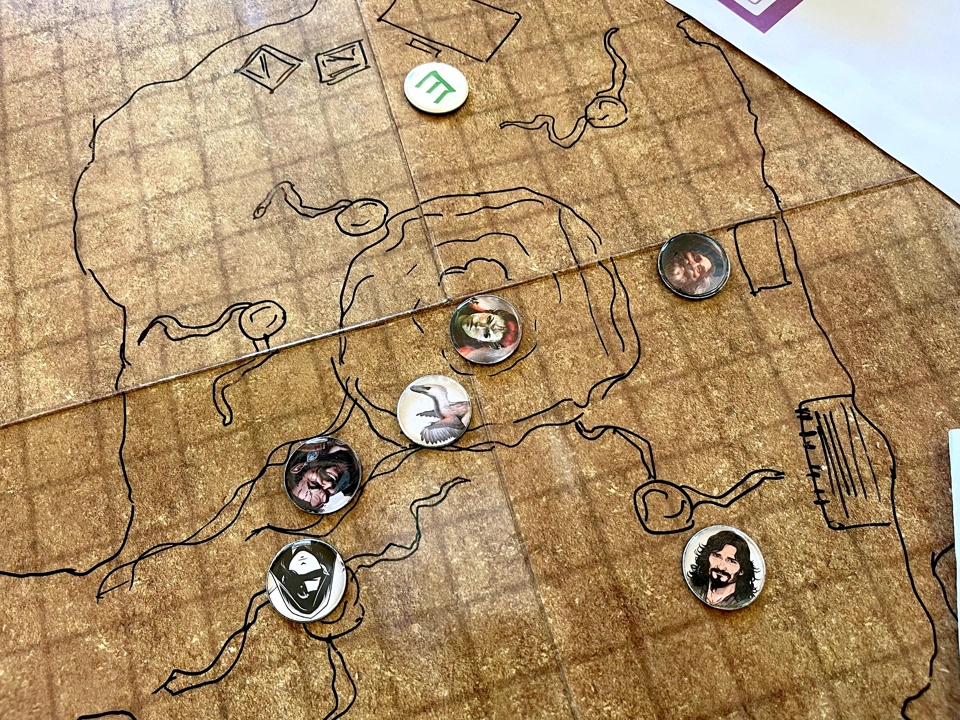 The party explores the cave while Valindra waits for them near her desk.