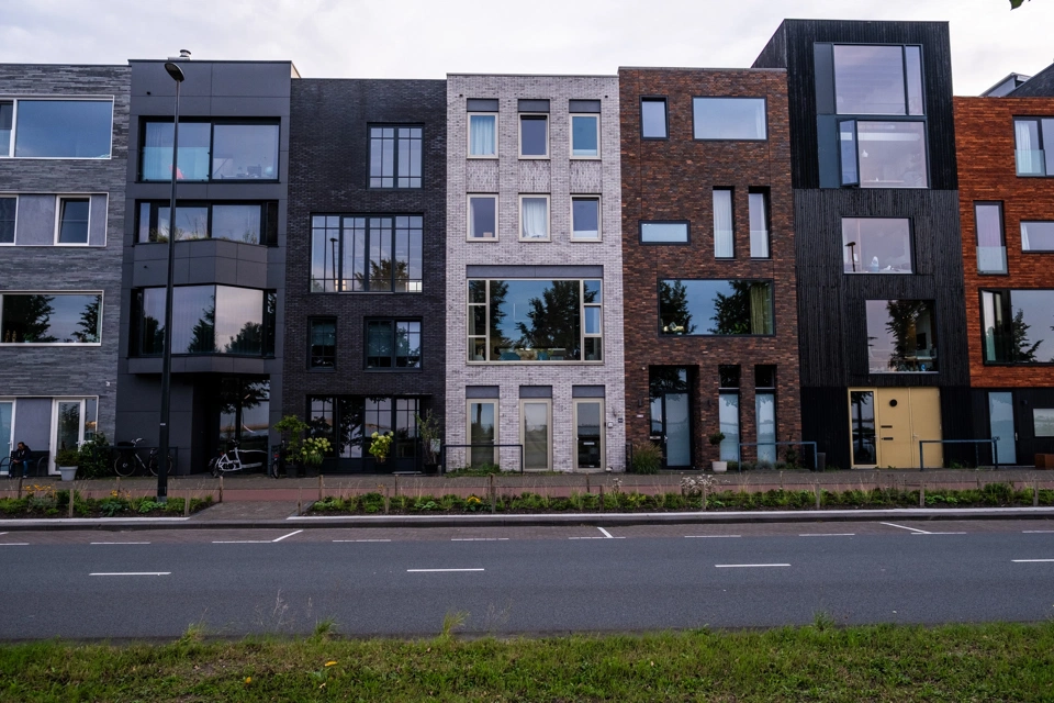 Modern buildings on Ijburg&rsquo;s promenade next to the Markemeer