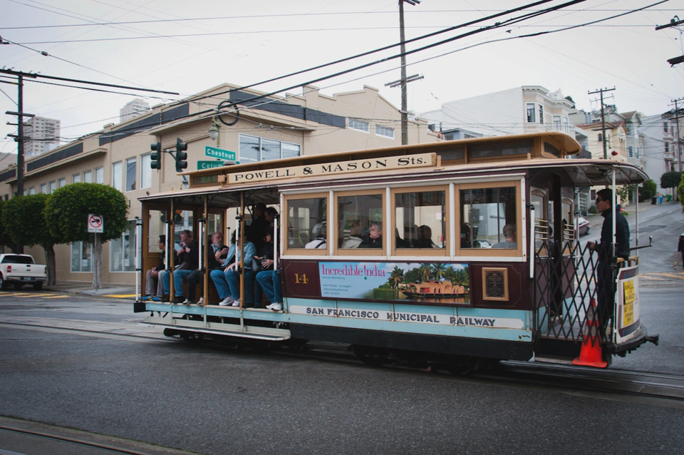 One of the many turquoise and red cable cars that cover the city.