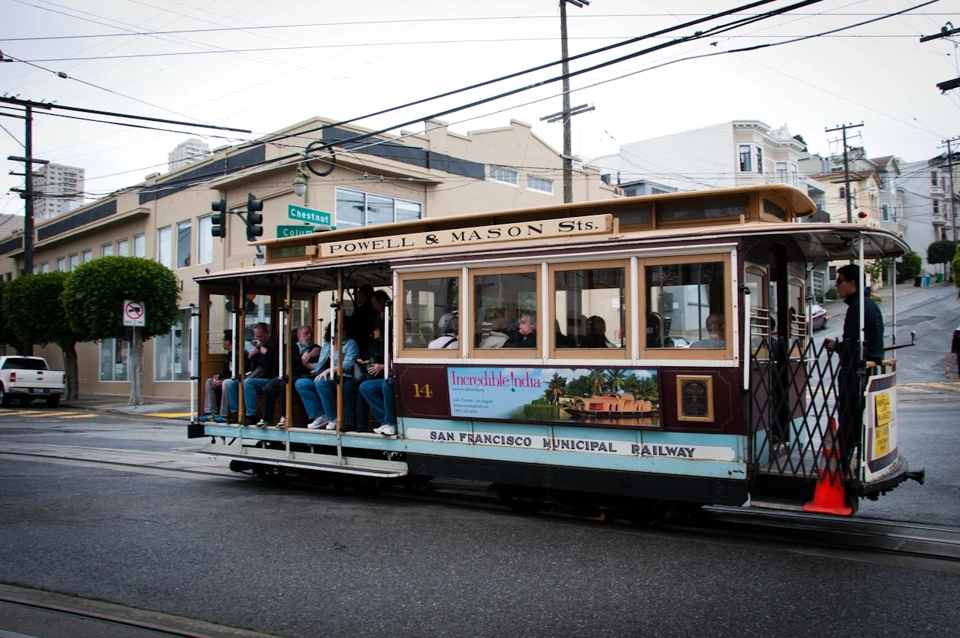 One of the many turquoise and red cable cars that cover the city.