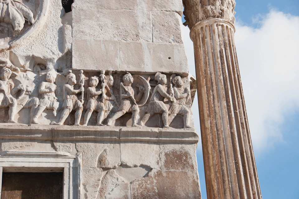 Ancient times cartoons decorating the Roman Triumphal Arc that stands a few steps away from the Colosseum.