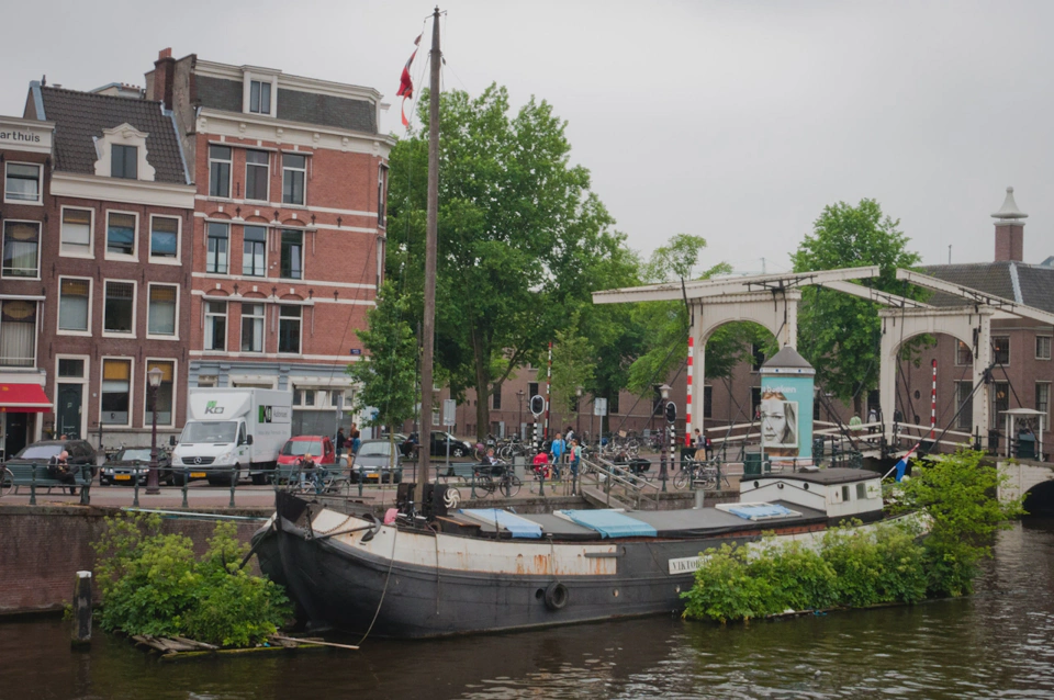 old-boat-with-plant-armor-on-a-canal.webp